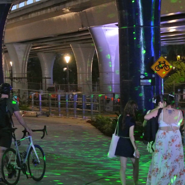 Cyclists and e-scooter users were asked to walk through the Sono Lumo light show, in the middle of the Bicentennial Bikeway.
