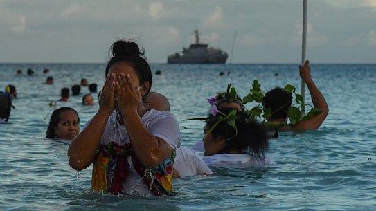 Locals demonstrate traditional fishing practice to round up fish to be cooked on an umu (traditional earth oven) by the lagoon in Funafuti, Tuvalu, on Thursday.