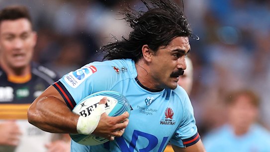 Charlie Gamble is tackled in the Waratahs’ Super Rugby opener on Friday.