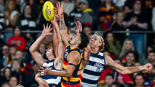 Izak Rankine of the Crows high in the pack over Tom Stewart of the Cats 