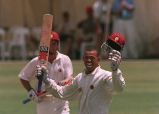 “Queensland’s Andrew Symonds celebrates his maiden first-class century against England at Toowoomba yesterday.”