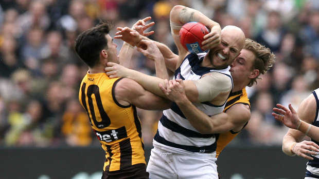 Batlle of the ages: Young Hawks Jaeger O'Meara and James Worpel take on Cats' veteran Gary Ablett.