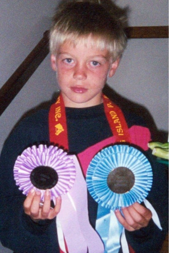 McSweyn at the King Island Show, holding his winning ribbons for a fun run and horse riding competition.