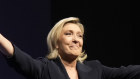 French far-right leader Marine Le Pen gestures after delivering her speech following the release of polling projections.