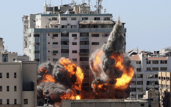 A ball of fire erupts from the media building in Gaza City after an Israeli airstrike.