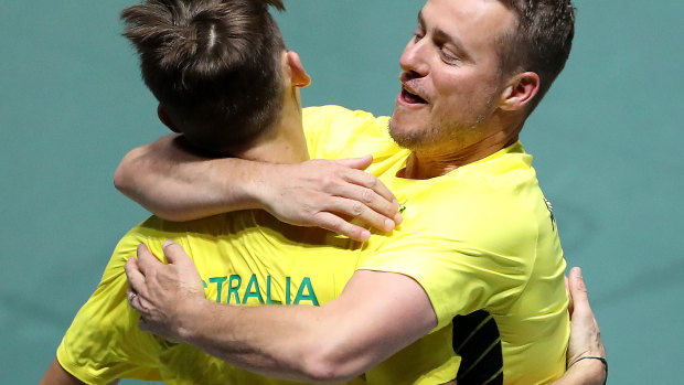 Hewitt embraces de Minaur during the recent Davis Cup teams event in Spain.