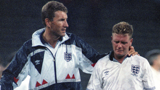Famous tears: Paul Gascoigne cries as he is escorted off the field by team captain Terry Butcher, after his England lost a penalty shoot-out in the semi-final of the World Cup against West Germany in Turin, Italy. 
