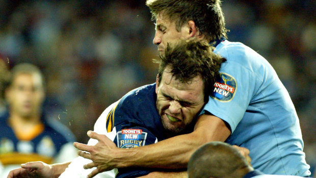 Old foes: Owen Finegan runs into some resistance against the Waratahs in 2004.