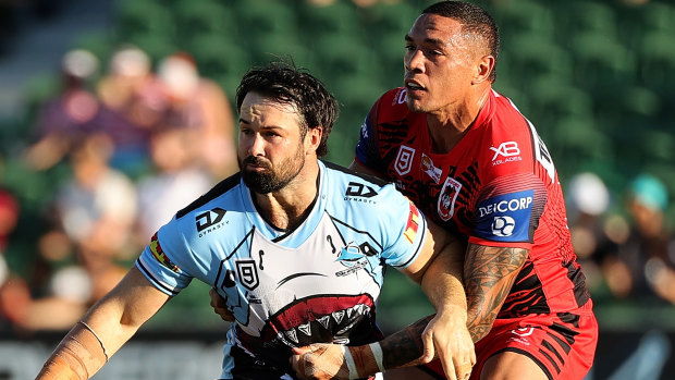 Aaron Woods offloads while being tackled by Tyson Frizell of the Dragons during day one of the Nines.