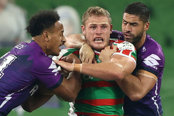 Souths' Tom Burgess is held up in Melbourne Storm's big win over the Rabbitohs.