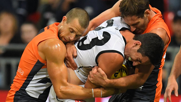 Carlton's Jacob Weitering is crunched by the Giants.