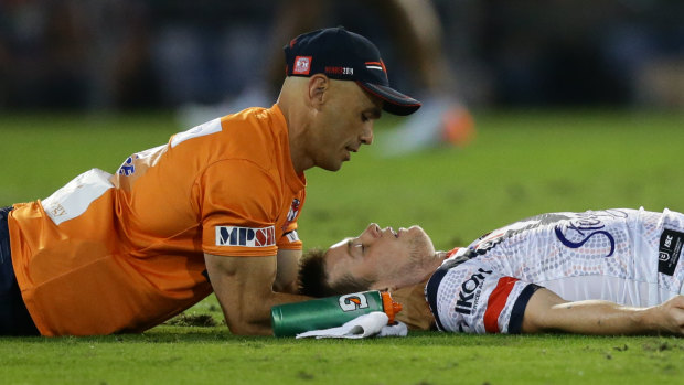 Down and out: Luke Keary receives attention after suffering a concussion. 