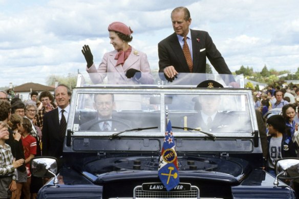 Queen Elizabeth II and Prince Philip wave to wellwishers from their open Land Rover in Wellington, New Zealand, in 1981.