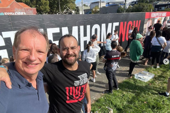 Businessman Mottel Gestetner (right), who organised the original poster, poses in front of the sign with deputy Victorian Liberal leader David Southwick.