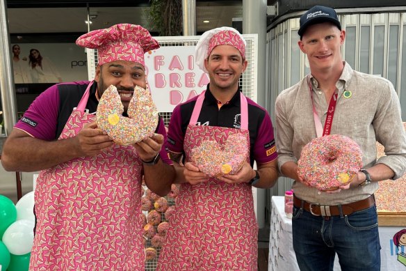 Sam Thaiday, Matt Gillett and Rowan Crothers eat doughnuts in the Queen Street Mall.