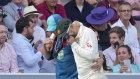 Australia’s Nathan Lyon is helped off the pitch after an injury.