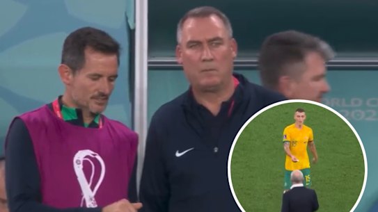Socceroos assistants Andrew Clark and Rene Meulensteen review the scrap of paper handed to Graham Arnold by Mitchell Duke.