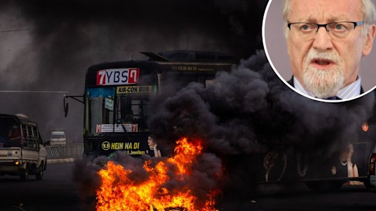 composite - YANGON, MYANMAR - APRIL 03: Smoke rises from tires set alight by anti-coup protesters on April 03, 2021 in Yangon, Myanmar. Myanmar’s military Junta continued a brutal crackdown on a nationwide civil disobedience movement in which thousands of people have turned out in continued defiance of live ammunition. Local media and monitoring organizations estimate that over 500 people have been killed since the coup began. (Photo by Getty Images/Getty Images). Gareth Evans talks during a panel at the 2018 Asean-Australia Dialogue at the PWC offices on March 13, 2018 in Sydney, Australia.  (Photo by Daniel Munoz/Fairfax Media)