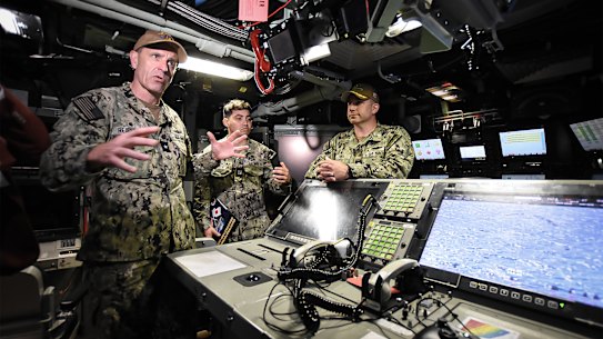 Rear Admiral Lincoln Reifsteck, left, speaks to media during a tour of the USS Vermont. 