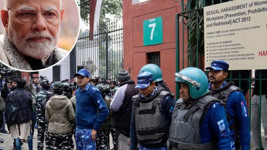 Security personnel guard the main gate of Jamia Millia Islamia university in New Delhi, India, Wednesday, Jan. 25, 2023. Tensions escalated in the university after a student group said it planned to screen a banned documentary that examines Indian Prime Minister Narendra Modi’s role during 2002 anti-Muslim riots, prompting dozens of police equipped with tear gas and riot gear to gather outside campus gates.

