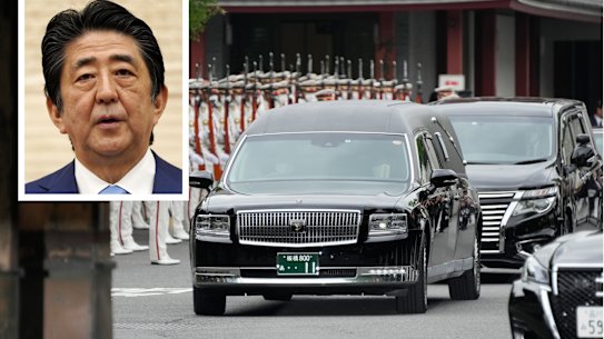 The vehicle carrying the body of former Japanese Prime Minister Shinzo Abe (inset) leaves Zojoji temple after his funeral in Tokyo on Tuesday.
