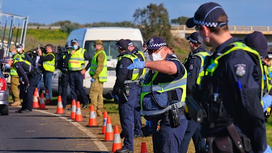 ADF personnel and Victoria Police at a checkpoint on the Princes Freeway on the outskirts of Melbourne during July. 