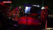 Authorities say the driver was rescued by being pulled from his vehicle by his hair.