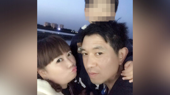 Xiaojun Chen (right) with his family, who have received a payout from his employer’s insurer.