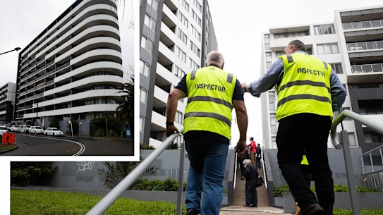 Building inspectors tour the apartment complex on Charles St Canterbury, where structural concerns have emerged this week.