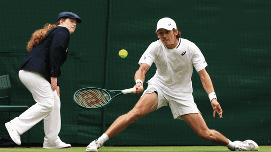 Alex de Minaur’s reaction was muted after advancing to the quarter-finals because of a hip injury.