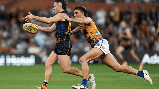 The Crows’ Jake Soligo gets caught holding the ball by Campbell Chesser, of the Eagles on Sunday.