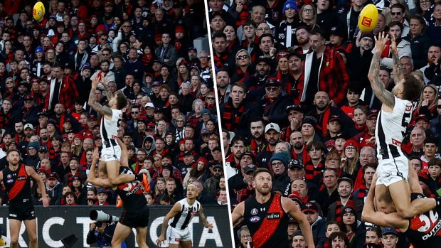 Collingwood’s Jamie Elliott takes a spectacular mark over Essendon’s Ben McKay at the Melbourne Cricket Ground.
