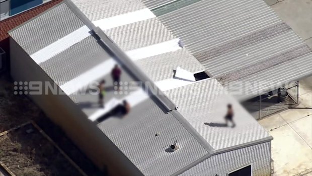 Youths on the roof of Banksia Hill on Monday. 