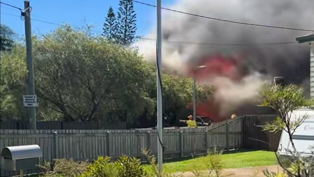 Three people have been assessed by paramedics outside a house fire in Redland Bay.