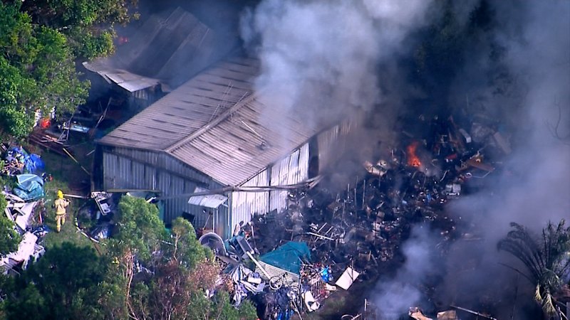 Residents told to stay indoors as fire rips through north Brisbane backyard