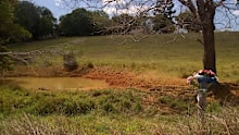 A girl and her step-mother were killed when their car crashed into a dam on the Fraser coast, with the girl’s father making the grim discovery.