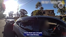 A Queensland driver was slapped with a hefty fine for allegedly steering with his knees while buttering a bagel.