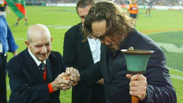 Russell Crowe rings the foundation bell with former player Albert Clift at South Sydney’s first game back in the competition in 2002. They played arch rivals the Roosters at the Sydney Football Stadium.