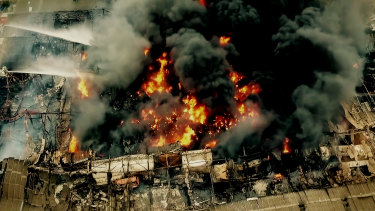 Firefighters on platforms battle the West Footscray factory fire of August 30, 2018. 