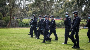 Police march through Elsternwick Park on Saturday