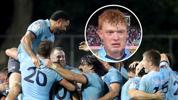 The Waratahs celebrate their win, while Tane Edmed gets emotional after the siren. 