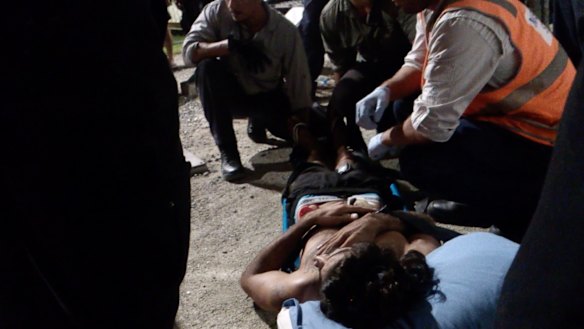 A detainee who has self-harmed is carried from his compound at night in footage from Behrouz Boochani's film with Arash Sarvestani,  <i>Chauka, Please Tell Us the Time</i>, released in 2017.