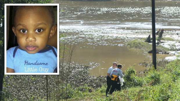 Rescue workers recover the body of one-year-old Kaiden Lee Welch in Union County on Monday. The child was swept away in floodwaters resulting from the remnants of Hurricane Florence on Sunday.