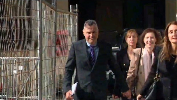 Stephen Kaless with his wife and legal team outside court on Monday.