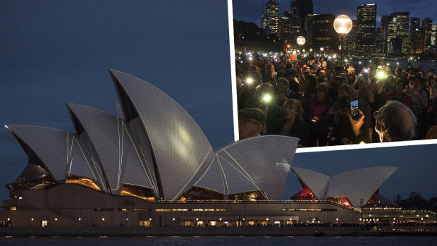 Protesters on the harbour foreshore opposing the projection of material, promoting the 2018 Everest Horse Race onto the sails of the Opera House.