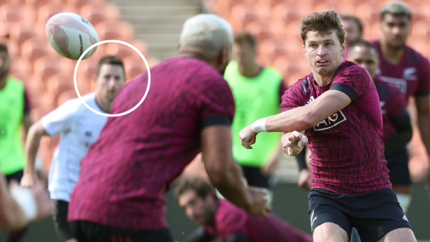 Beauden Barrett (left) trains with the All Blacks, with referee Paul Hamilton in the background (right). 