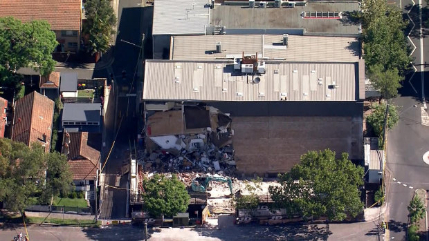 Workers were evacuated before a large part of a commercial building in Crows Nest collapsed on Monday afternoon.