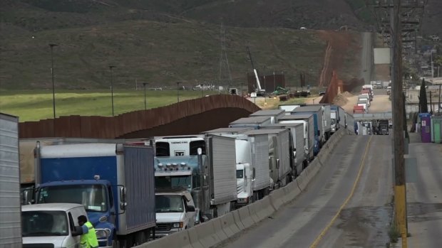 Trucks line up along the US-Mexico border. Donald Trump has threatened to impose tariffs on all Mexican goods if its neighbour doesn't stem the flow of migrants into the US.