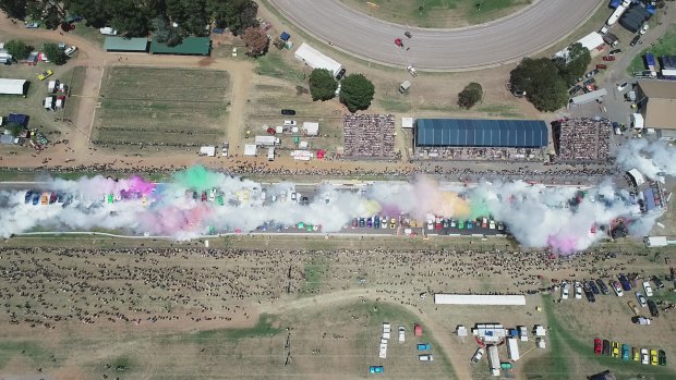 A drone shot of the assembled cars beginning their Summernats burnout record attempt