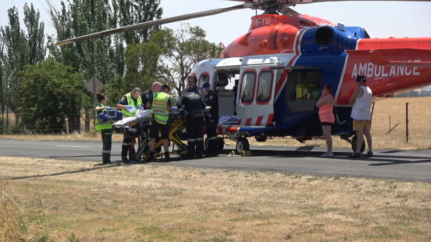 The injured boy is loaded into air ambulance.